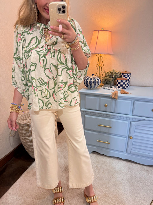 Textured floral printed blouse featuring batwing sleeves with front ties